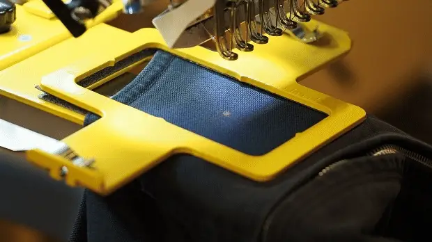Close-up of an embroidery machine stitching a pocket panel