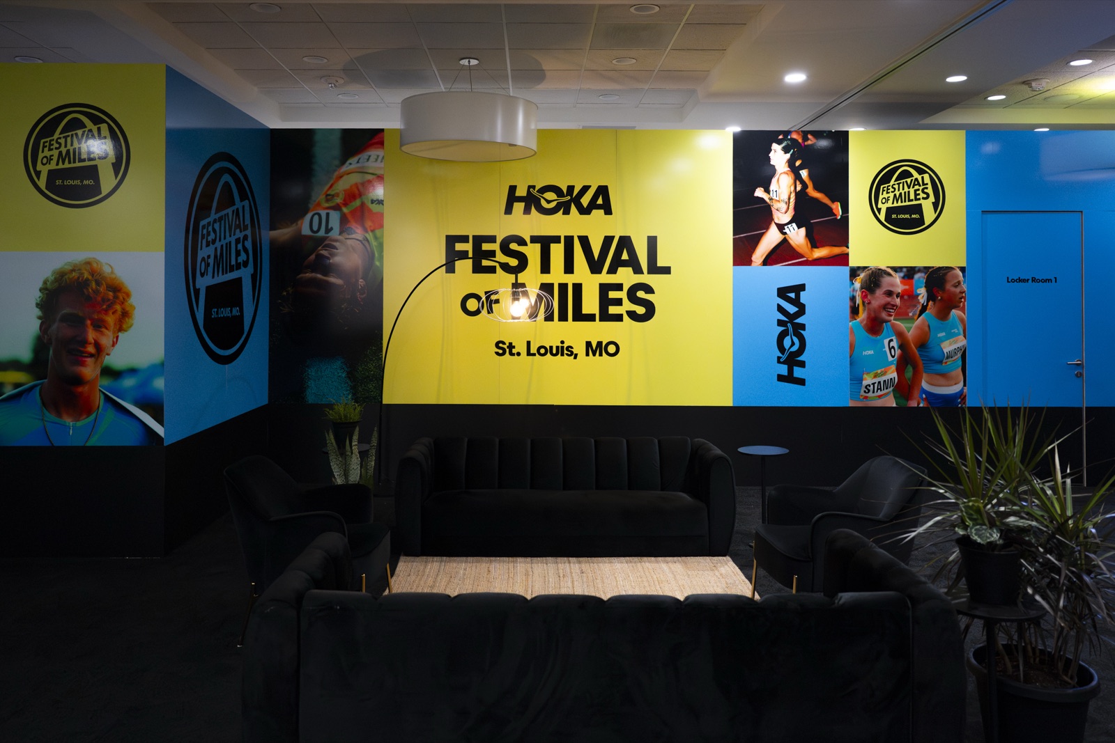 Athlete lounge interior fully wrapped in HOKA Festival of Miles graphics outside Locker Room 1
