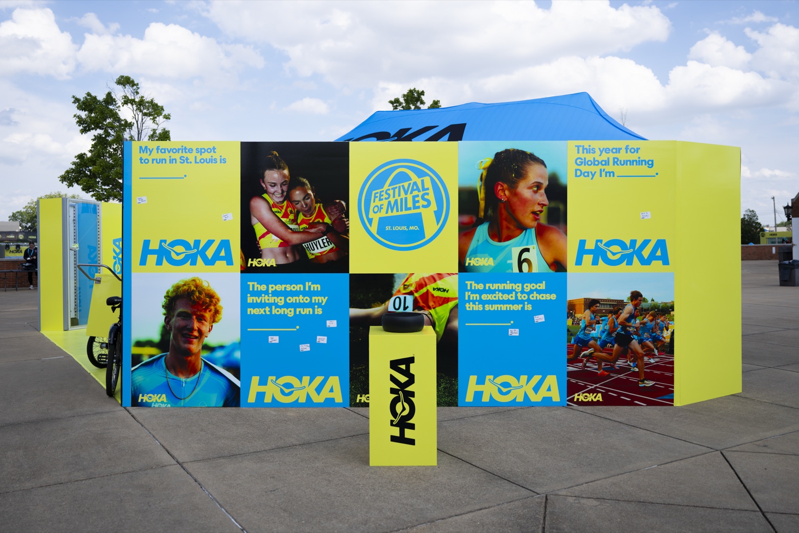HOKA Fan Zone walls at Festival of Miles: athlete photography and fill-in-the-blank prompt panels covered in fans’ handwritten notes