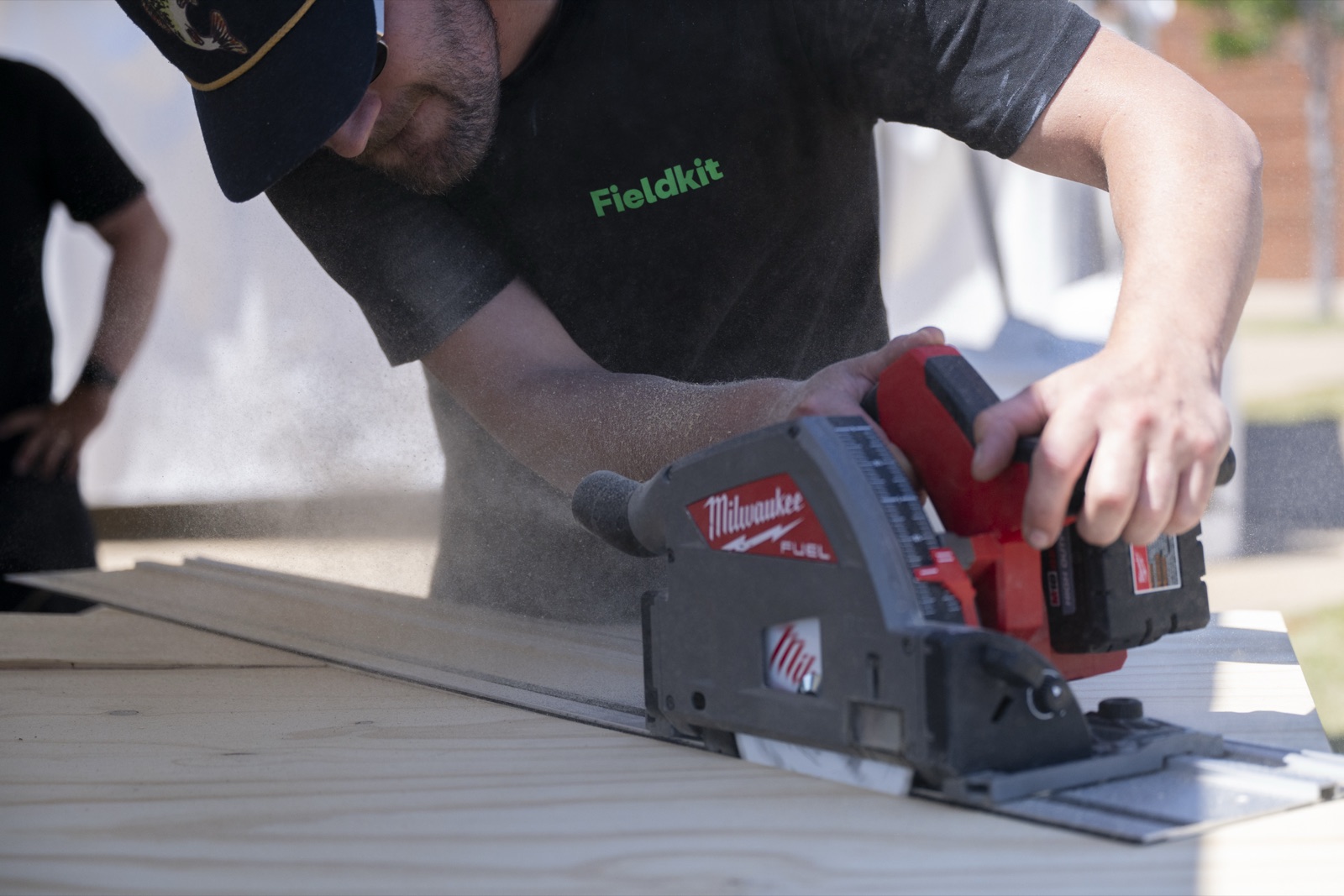 Fieldkit crew member track-sawing plywood on site during the Festival of Miles install